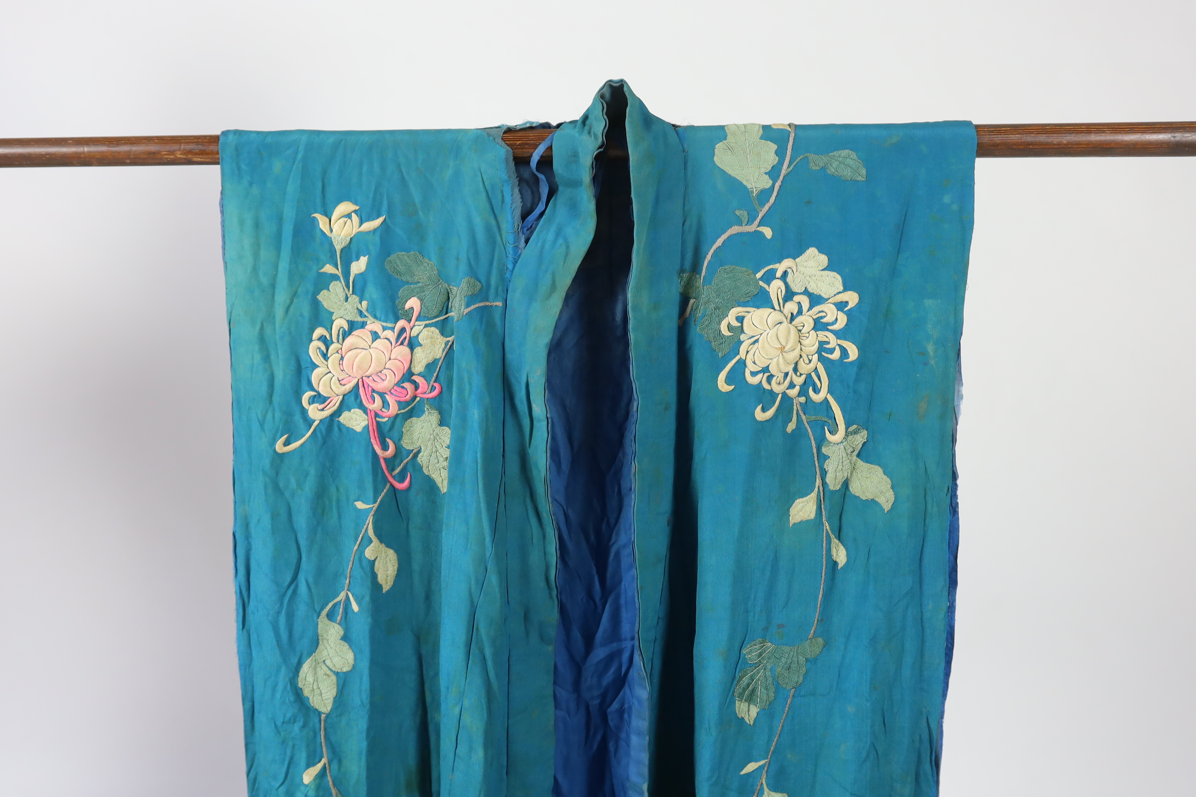 An early 20th century silk crêpe Japanese kimono and fringed tie belt, the back panel heavily embroidered with trailing chrysanthemum type flowers and leaves. This item is being sold for the back panel only and is with a